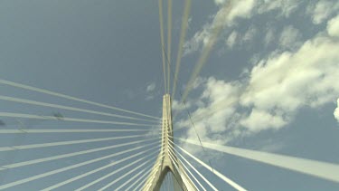 Suspension cables on a bridge and clouds in a blue sky