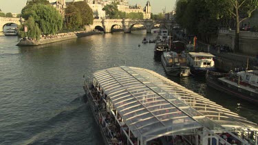 Boat under the Pont Neuf bridge on the Seine river in Paris, France