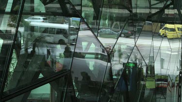 Time lapse of pedestrians on a busy street reflected in glass