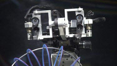 Close up of a robotic mechanism with a purple spring