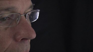 Close up of a man wearing glasses looking at a computer screen