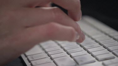 Close up of a person typing on a keyboard