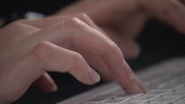 Close up of a person typing on a keyboard