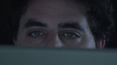 Close up of a man looking at his computer screen