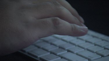 Close up of a person typing on a keyboard