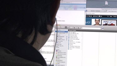 Close up of a man wearing earbuds using a computer