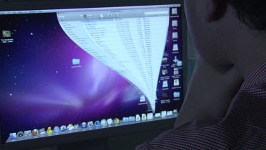 Close up of a person using an Apple computer