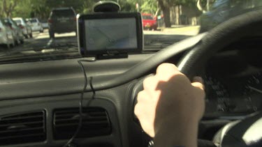 Driving a car with a GPS on the dashboard