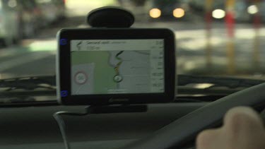 Driving a car with a GPS on the dashboard