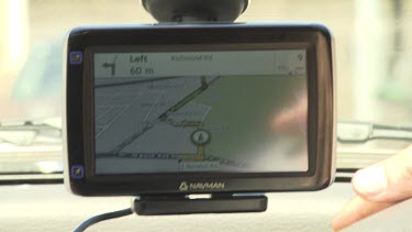Person configuring a GPS on their car's dashboard