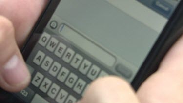 Close up of a person texting on a smartphone