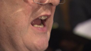 Close up of a man singing in a church choir