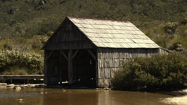 Wooden shelter at the edge of a lake