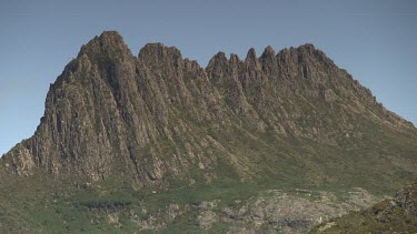 Rocky mountaintops against a blue sky