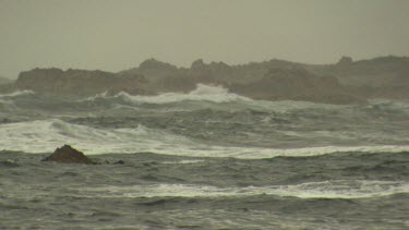 Rough waves breaking against a rocky shore