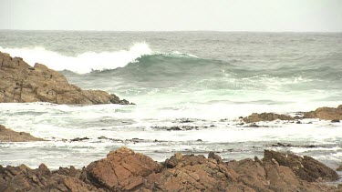 Rough waves breaking against a rocky shore