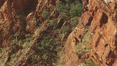Tall, rocky mountain cliff against a blue sky