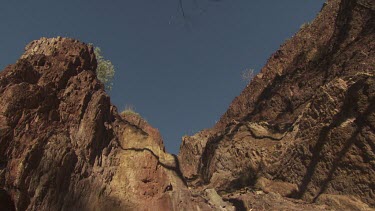 High rocky cliffs against a blue sky