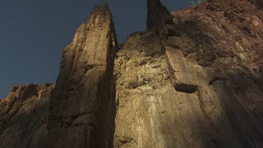 High rocky cliffs against a blue sky