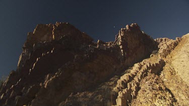 High rocky cliffs against a blue sky