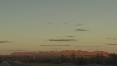 Red rocky mountain ridge and hazy landscape