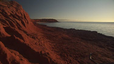 Close up of a red rocky dune on a beach