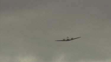 Small airplane in flight in a cloudy sky