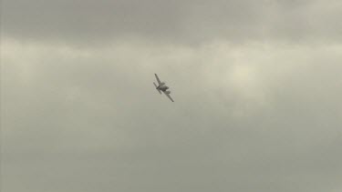 Small airplane in flight in a cloudy sky