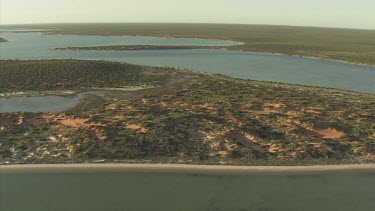 Coast and pools ringed by desert vegetation