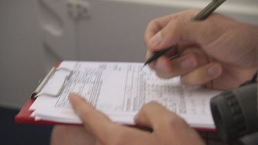 Close up of researcher filling out a checklist