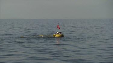 Yellow buoy floating on the ocean