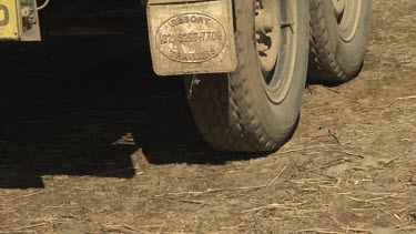 Close up of a truck's wheels driving a dirt road