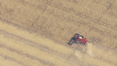 Wheat harvester farming a golden field