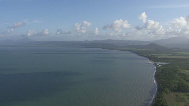 Aerial view of the ocean and a forested coast in Daintree National Park