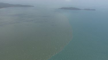 Aerial view of vegetation in the deep, cloudy ocean in Daintree National Park