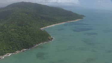 Aerial view of the ocean and a forested coast in Daintree National Park