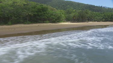 Aerial view of the ocean and a forested coast in Daintree National Park