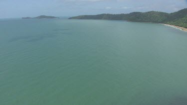 Aerial view of the ocean and a forested coast in Daintree National Park