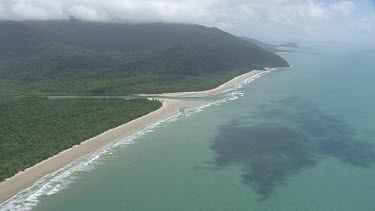 Aerial view of the ocean and a forested coast in Daintree National Park