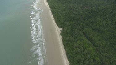 Aerial view of the ocean and a forested coast in Daintree National Park