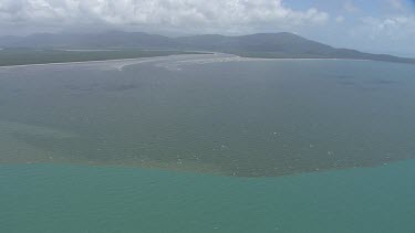 Aerial view of the ocean and a forested coast in Daintree National Park