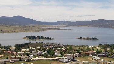 Aerial of Kosciuszko National Park -Town with forest and river landscape in the background