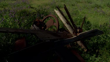 Rusty farm machinery tilt up to stone shed