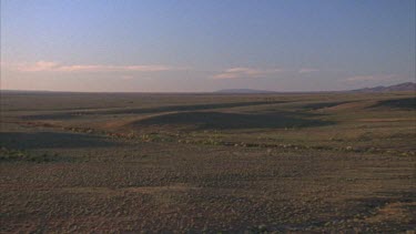 grasslands pan to western slopes of ranges