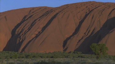 Uluru surface showing undulating rock and light and shade full frame rock