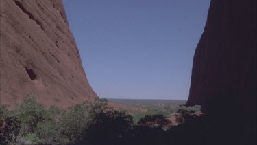 looking out from Walpa Gorge sheer rock faces of Kata Juta and onto sand plains