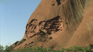 pan across Uluru surface the brain weathered arkase rock vegetation at base tilt to top