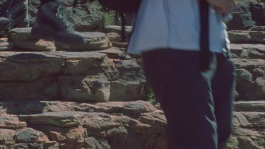 boots walking down natural rock steps of Kings Canyon shots also without boots