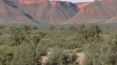 wide establishing shot of Canyon from a distance with flat landscape in foreground