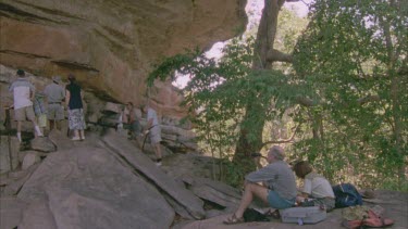 Ubirr rock art site with tourist looking and photographing